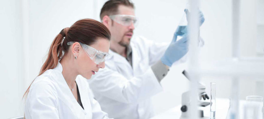 Scientists in a modern laboratory wearing safety goggles, conducting research experiments using advanced equipment, symbolizing HeGo Biotec's commitment to innovation and environmental sustainability.